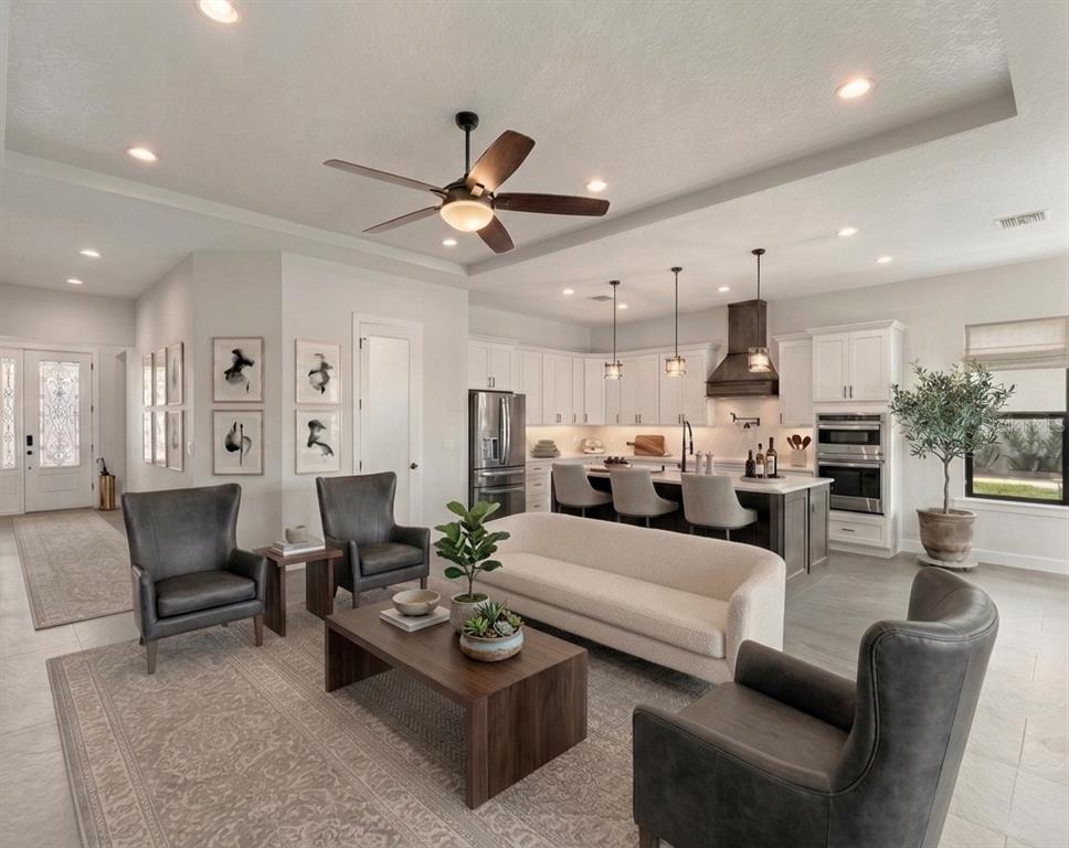 224 Valencia Ridge Drive Auburndale, FL 33823 - Photo 8 of 39 a living room with furniture kitchen view and a chandelier