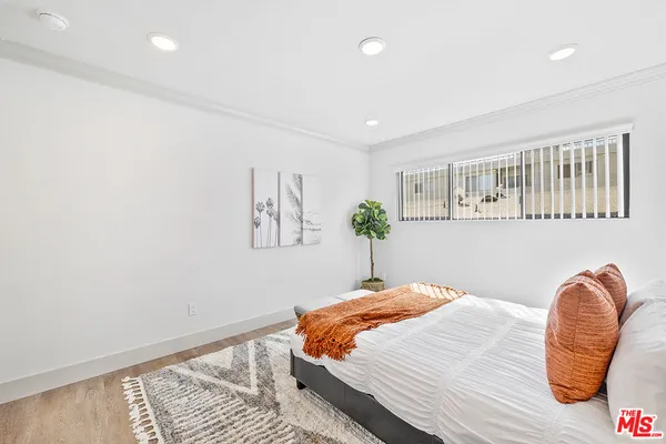 a bedroom with a bed and a chair