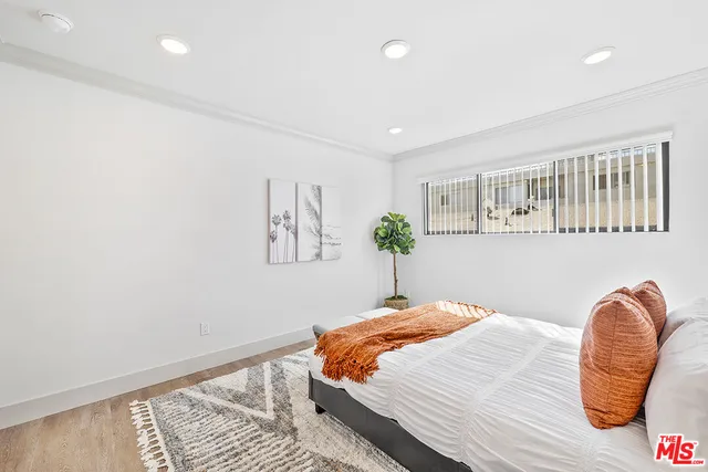 a bedroom with a bed and a chair