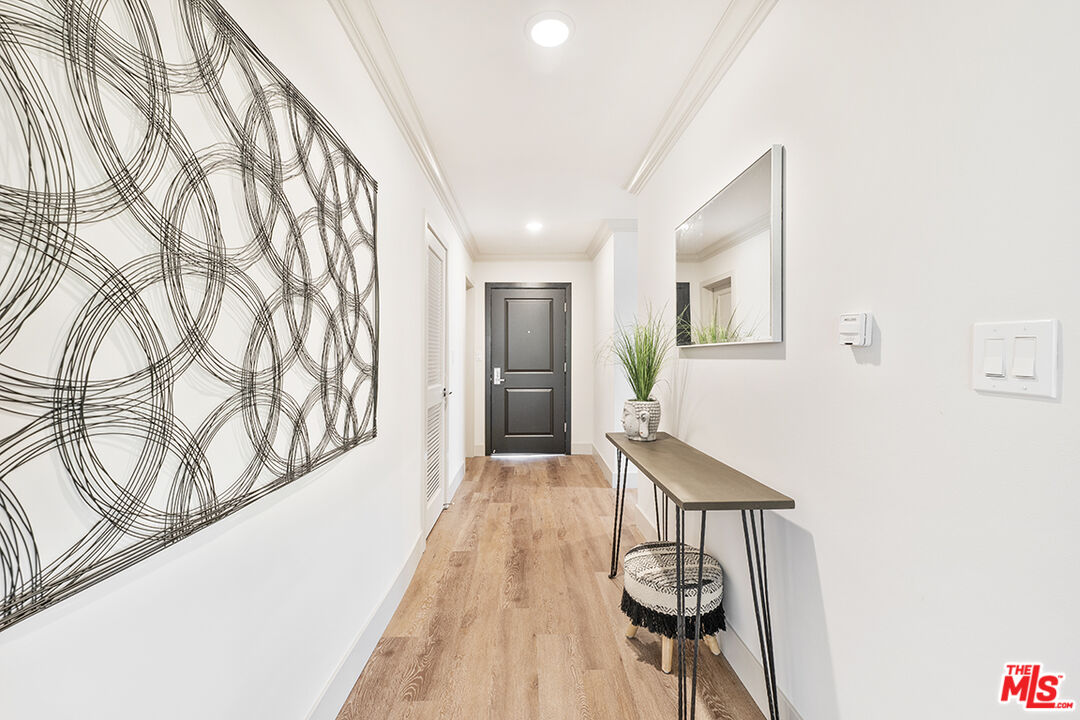 821 3rd Street, Unit 209 Santa Monica, CA 90403 - Photo 16 of 25 a view of a hallway with wooden floor and staircase