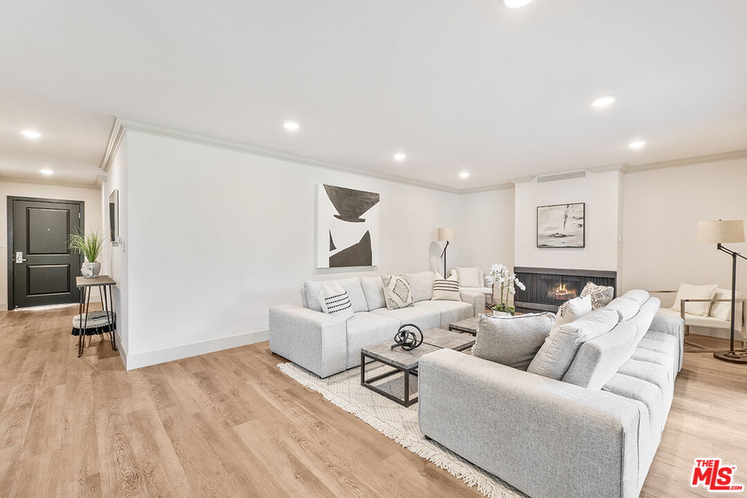821 3rd Street, Unit 209 Santa Monica, CA 90403 - Photo 17 of 25 a living room with furniture and a wooden floor
