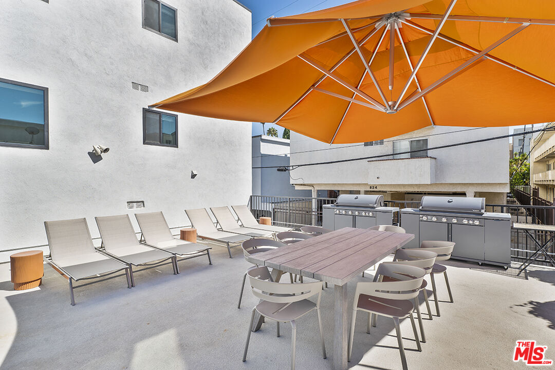 821 3rd Street, Unit 209 Santa Monica, CA 90403 - Photo 18 of 25 a patio with a table and chairs