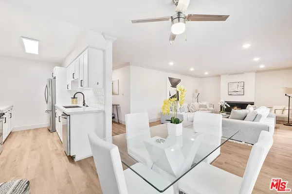 a living room with furniture and a kitchen view