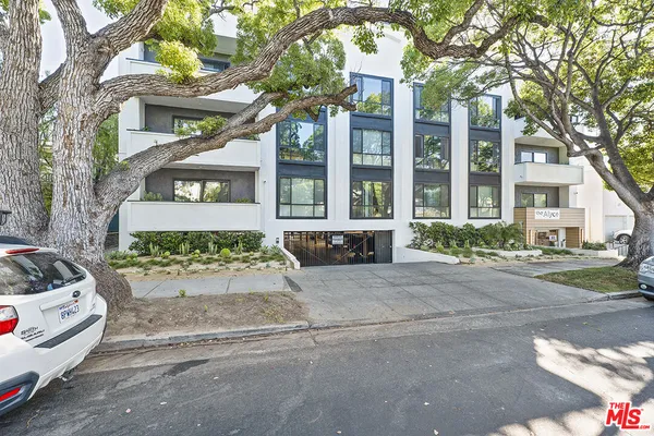 a front view of a residential apartment building with yard