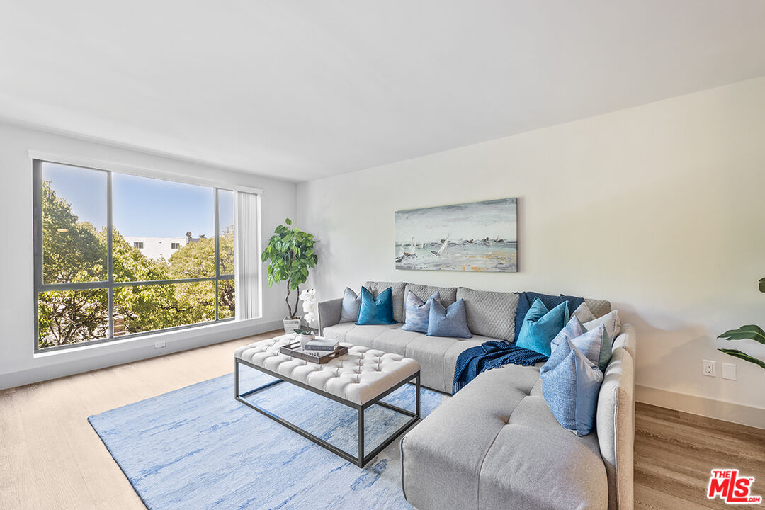 821 3rd Street, Unit 209 Santa Monica, CA 90403 - Photo 25 of 25 a living room with furniture and a large window