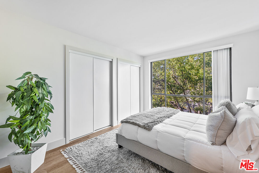821 3rd Street, Unit 209 Santa Monica, CA 90403 - Photo 4 of 25 a bedroom with a bed plant and a window