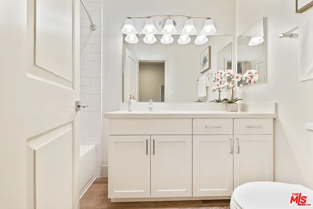 a bathroom with a sink vanity and mirror