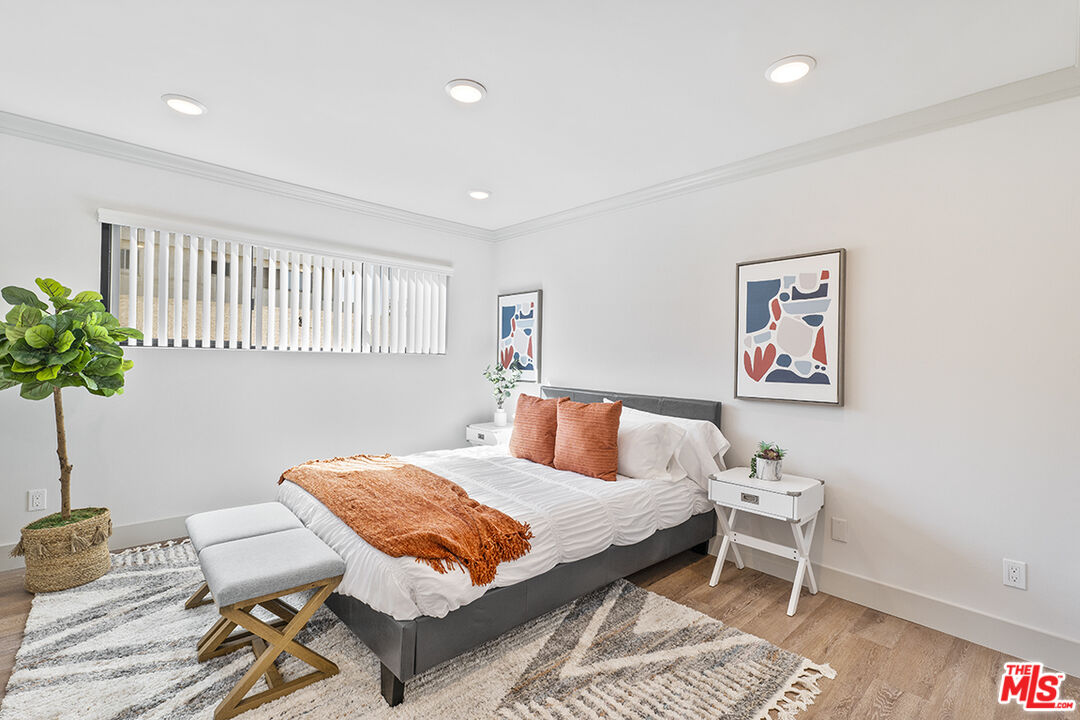 821 3rd Street, Unit 209 Santa Monica, CA 90403 - Photo 10 of 25 a bedroom with a bed and a table