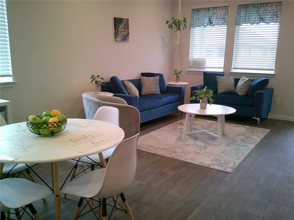 a view of a dining room with furniture and wooden floor