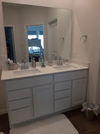 a bathroom with a double vanity sink and a mirror