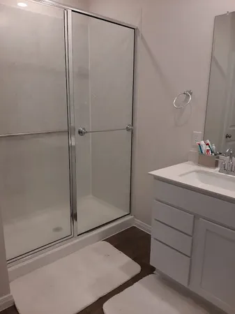 a bathroom with a shower and a sink