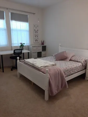 a bedroom with a bed and a table