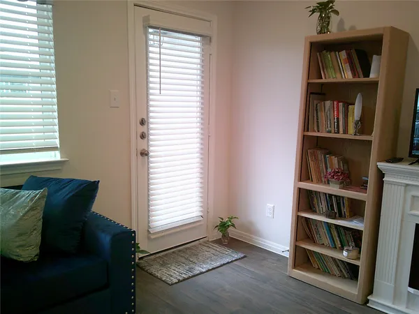 a living room with furniture and a book shelf