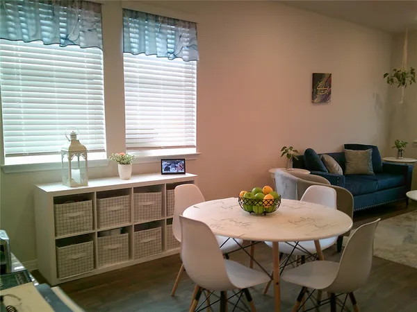 a view of a dining room with furniture and window
