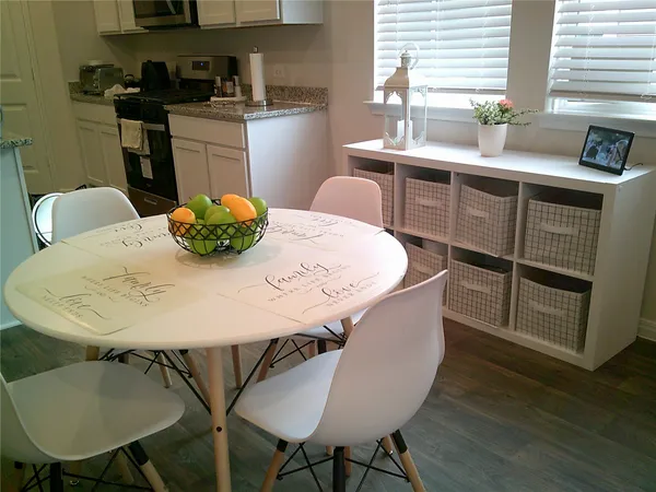 a dining table with chairs and wooden floor