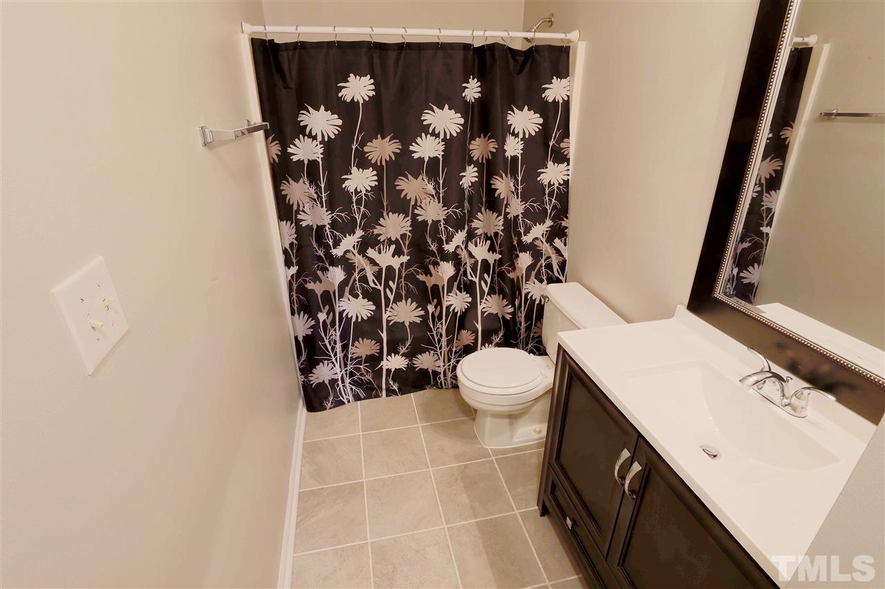 3533 Mill Run, Unit N/A Raleigh, NC 27612 - Photo 13 of 19 a bathroom with a toilet sink and shower