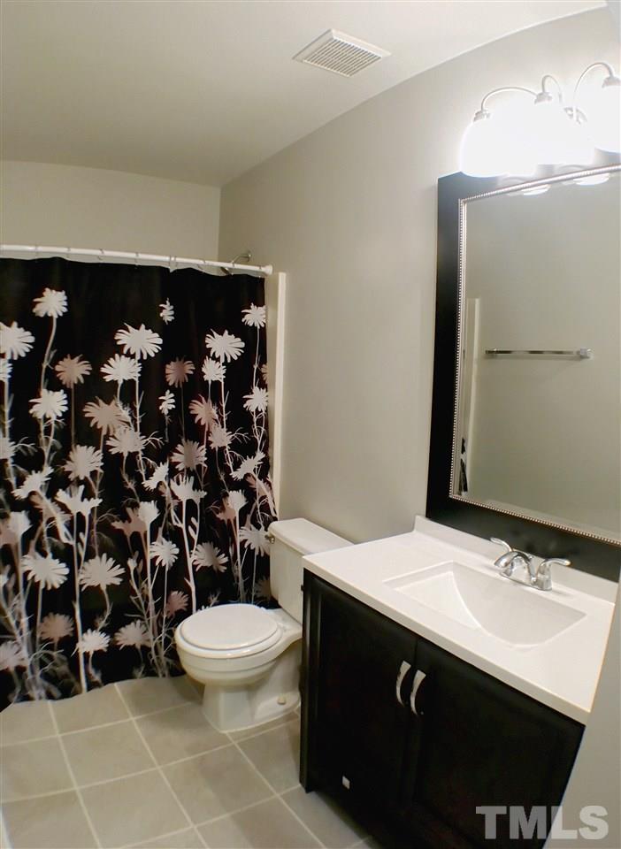 3533 Mill Run, Unit N/A Raleigh, NC 27612 - Photo 14 of 19 a bathroom with a sink toilet and shower