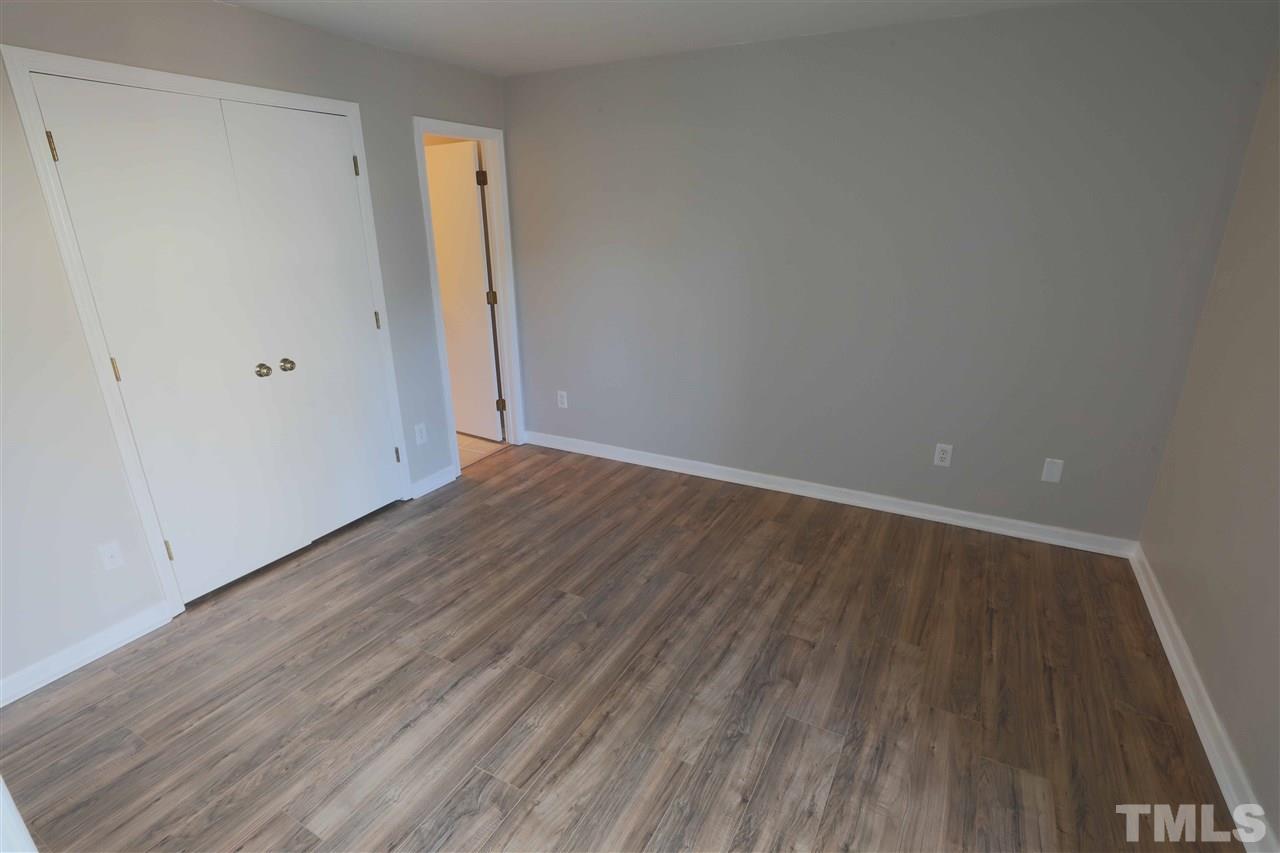 3533 Mill Run, Unit N/A Raleigh, NC 27612 - Photo 15 of 19 a view of an empty room with wooden floor and closet