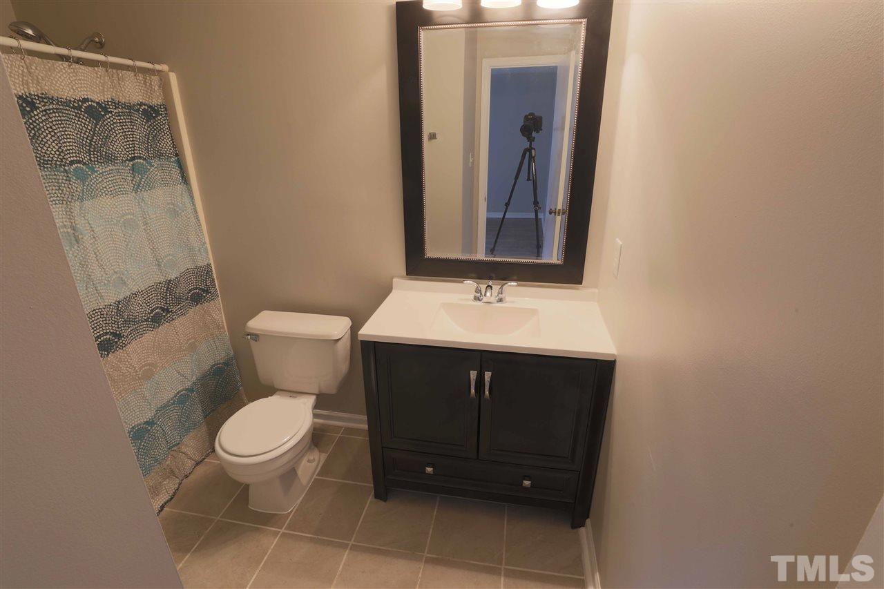 3533 Mill Run, Unit N/A Raleigh, NC 27612 - Photo 16 of 19 a bathroom with a sink and a toilet
