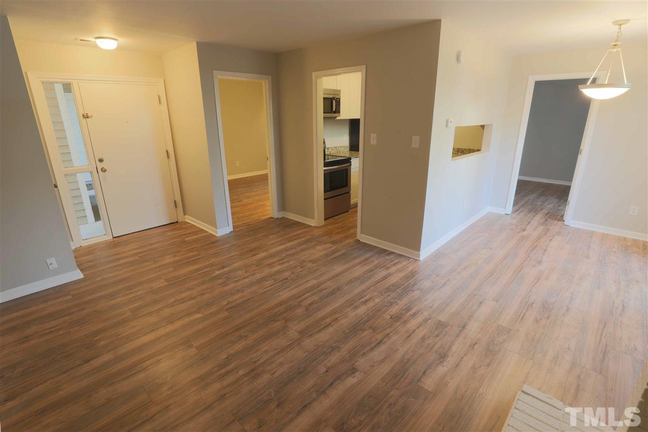 3533 Mill Run, Unit N/A Raleigh, NC 27612 - Photo 7 of 19 a view of empty room with wooden floor and window