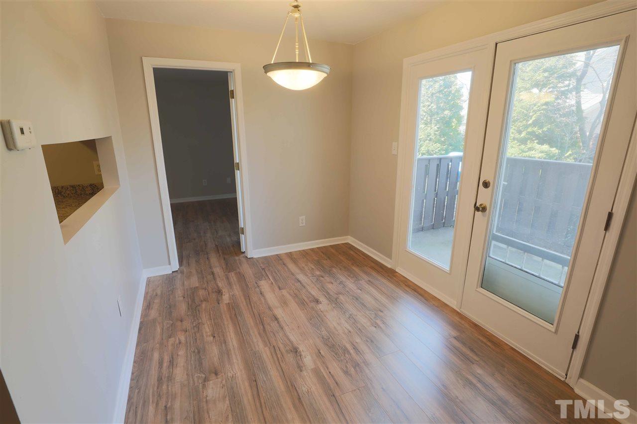 3533 Mill Run, Unit N/A Raleigh, NC 27612 - Photo 8 of 19 a view of empty room with wooden floor and fan