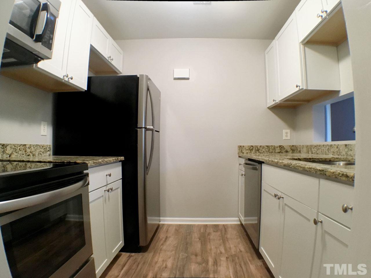 3533 Mill Run, Unit N/A Raleigh, NC 27612 - Photo 9 of 19 a kitchen with a stove and a microwave