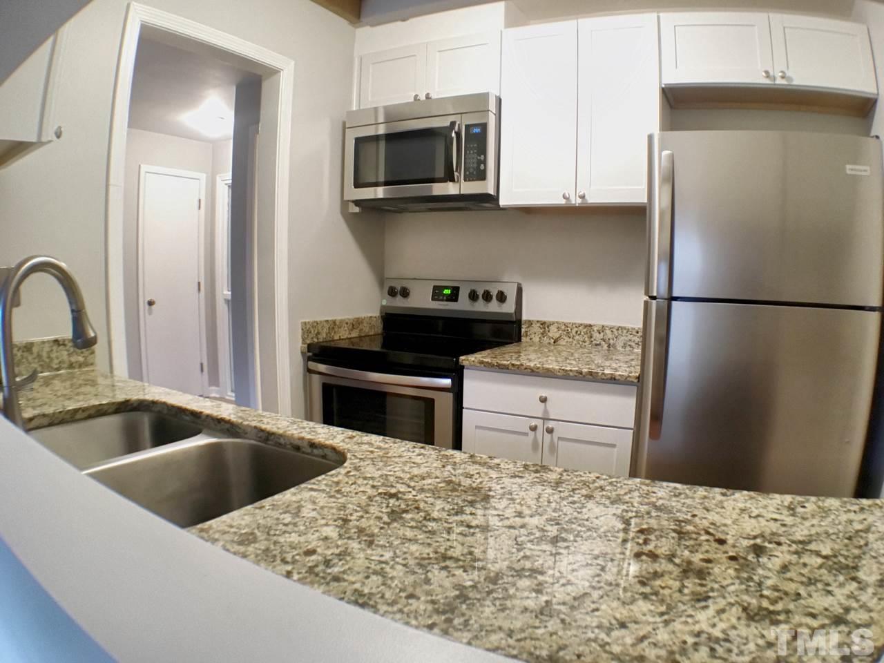 3533 Mill Run, Unit N/A Raleigh, NC 27612 - Photo 10 of 19 a kitchen with a refrigerator and a sink