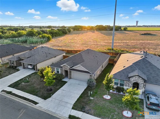 an aerial view of house with yard swimming pool and outdoor seating