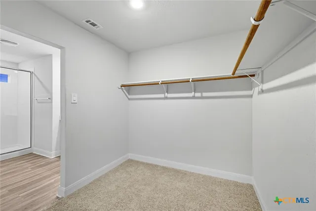 a bedroom with a bed and chair