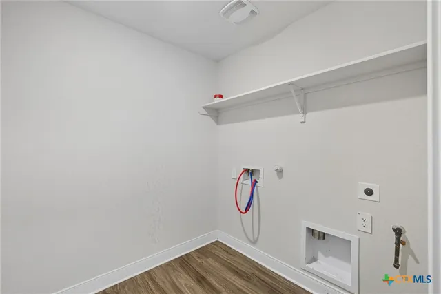 a view of an empty room with kitchen