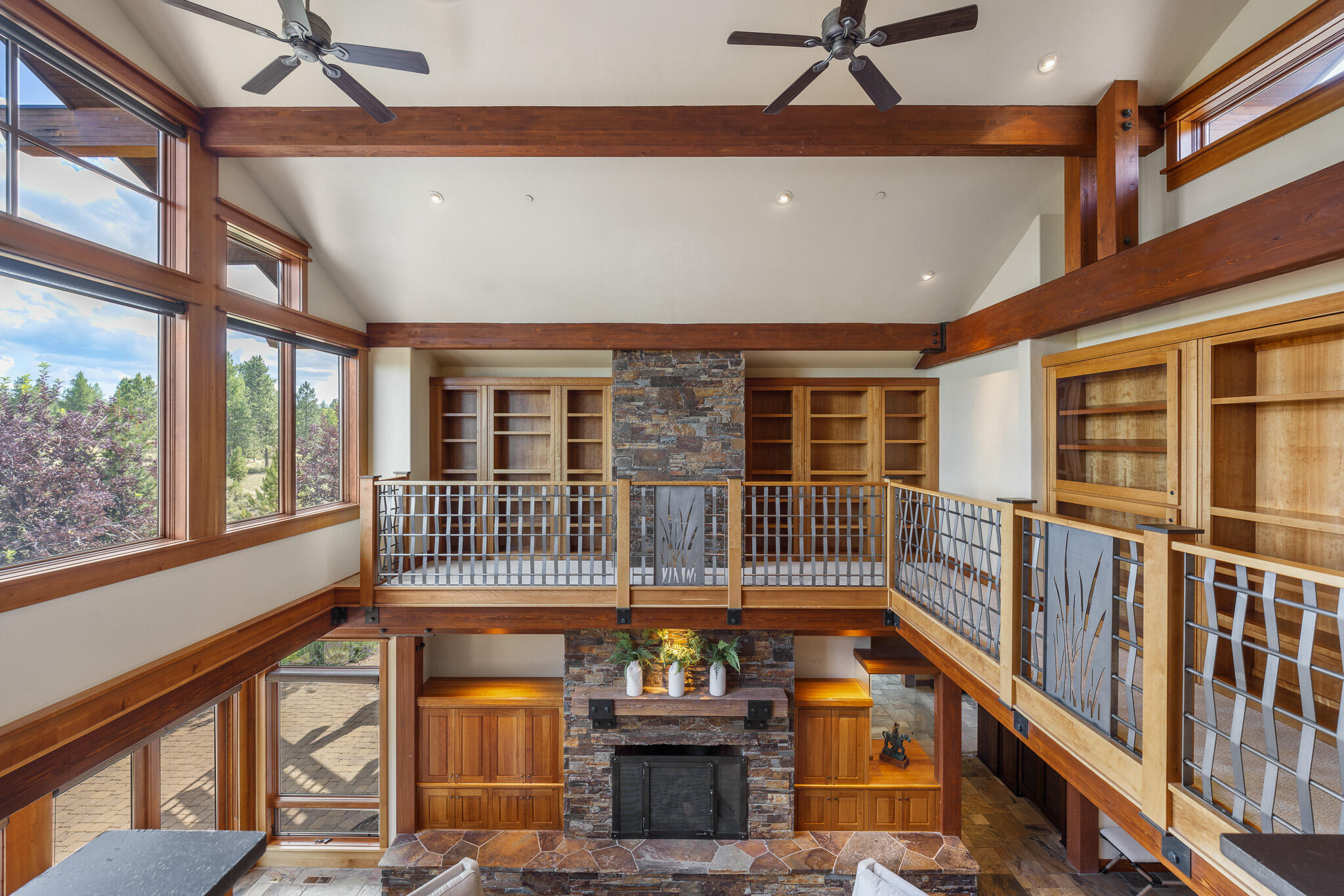 18883 Sutherland Court Bend, OR 97702 - Photo 32 of 70 A stunning overlook library with custom shelving and views across the great room and beyond.