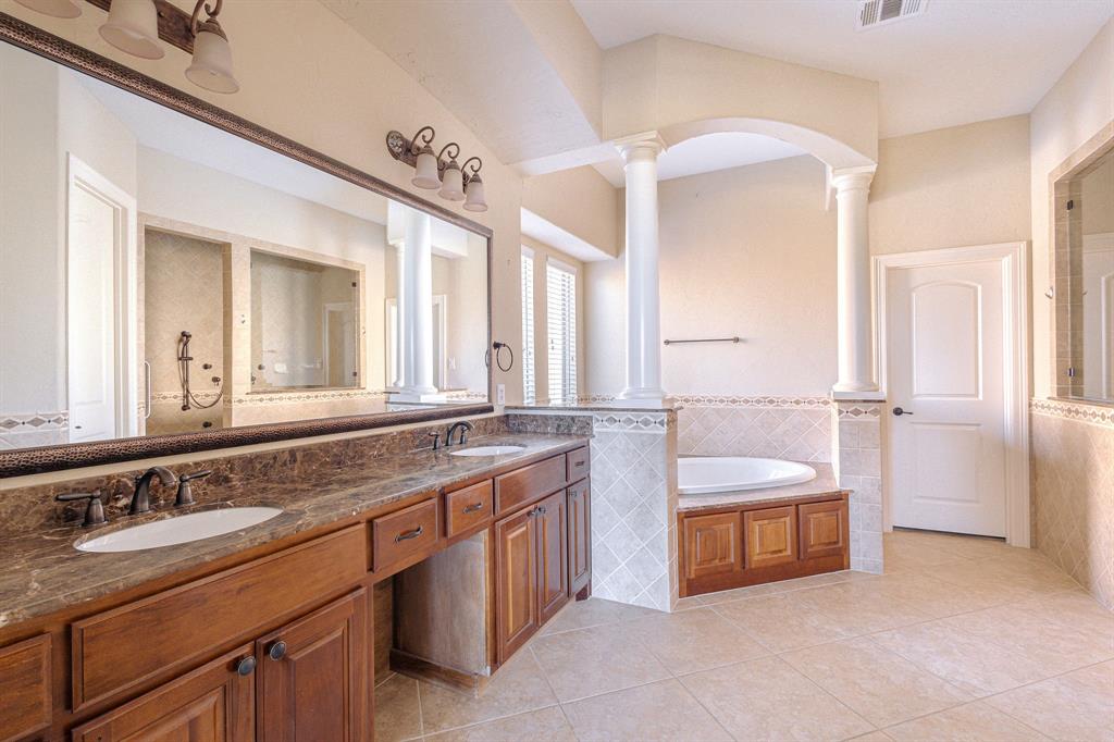 2207 Galloway Boulevard Trophy Club, TX 76262 - Photo 16 of 36 a spacious bathroom with a double vanity sink double mirror and bathtub