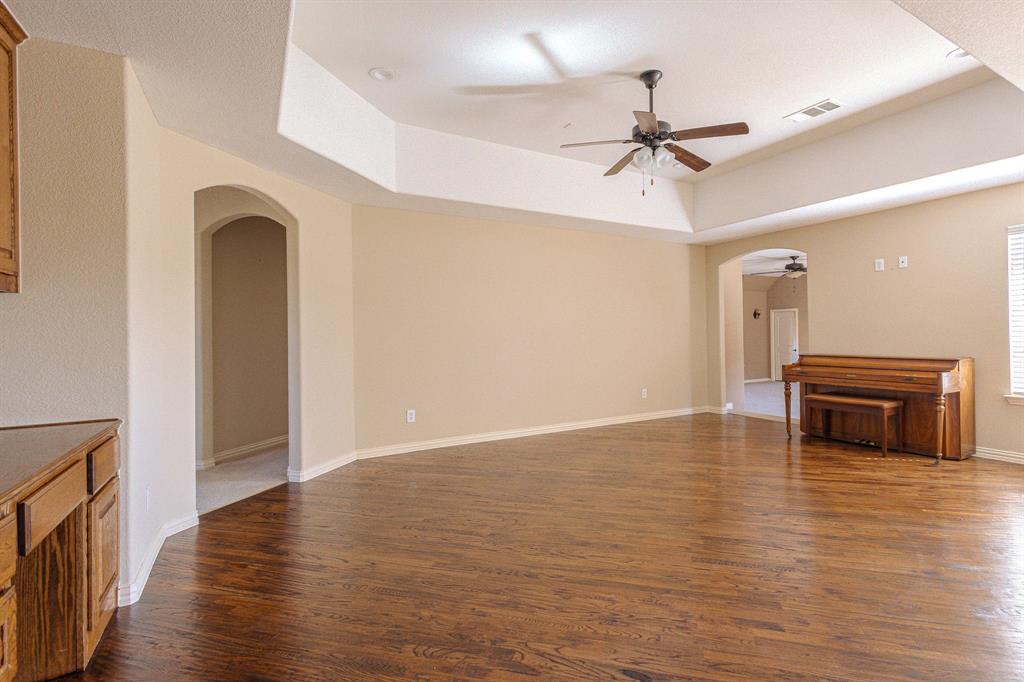 2207 Galloway Boulevard Trophy Club, TX 76262 - Photo 27 of 36 a view of an empty room with wooden floor and a ceiling fan