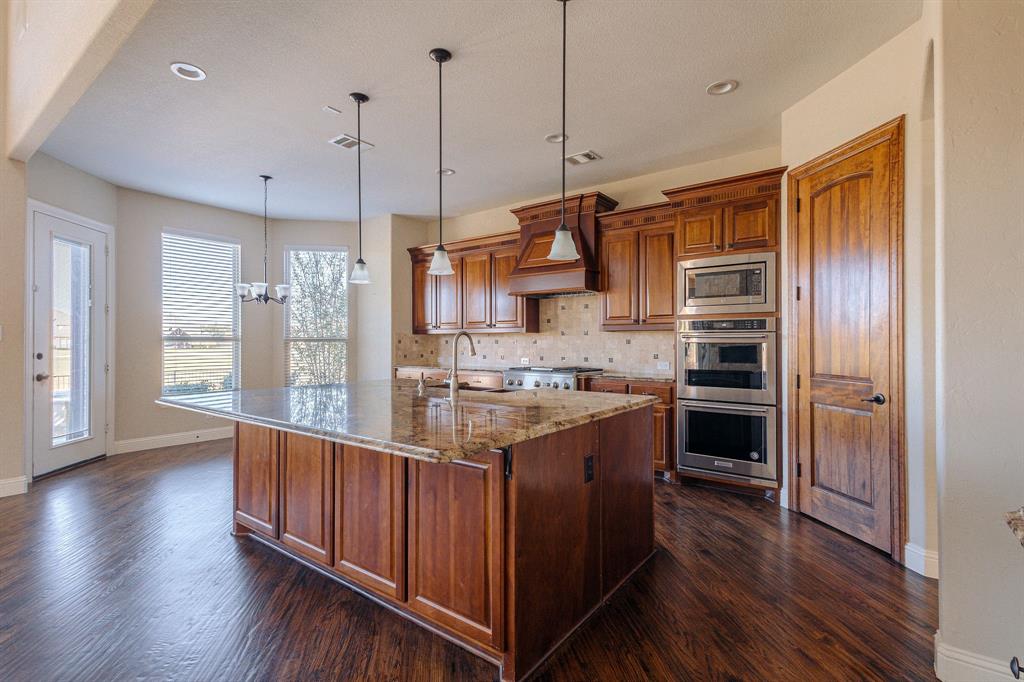 2207 Galloway Boulevard Trophy Club, TX 76262 - Photo 8 of 36 a kitchen with stainless steel appliances granite countertop a stove and a refrigerator