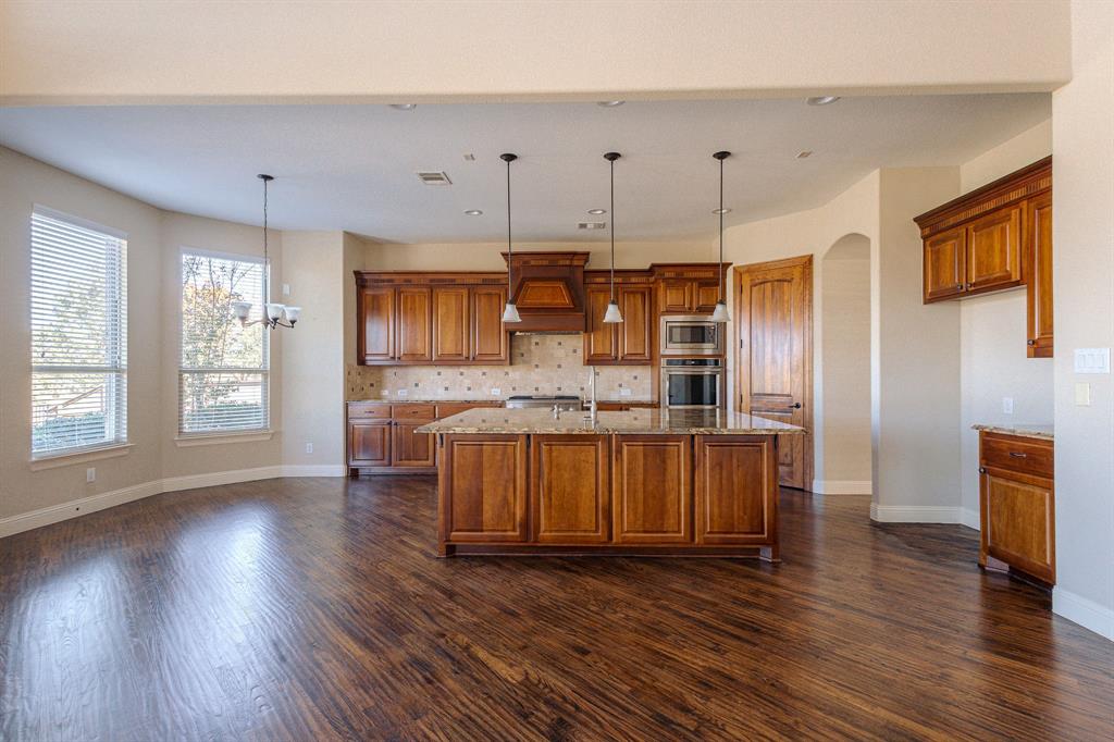 2207 Galloway Boulevard Trophy Club, TX 76262 - Photo 9 of 36 a kitchen with stainless steel appliances granite countertop a wooden floors a sink and a stove