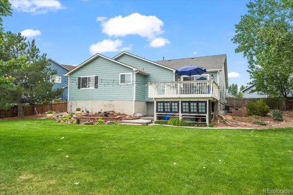 a view of a house with a yard and sitting area