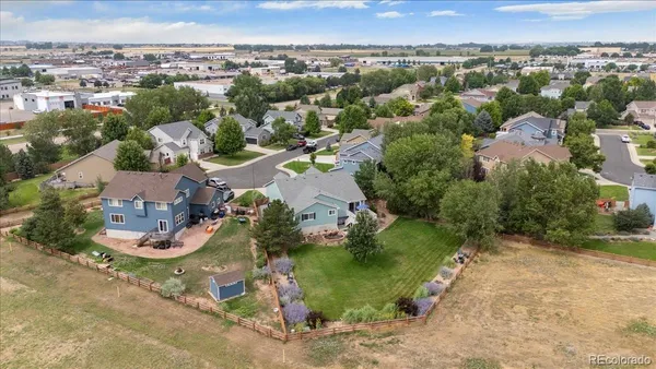 an aerial view of a house with a yard