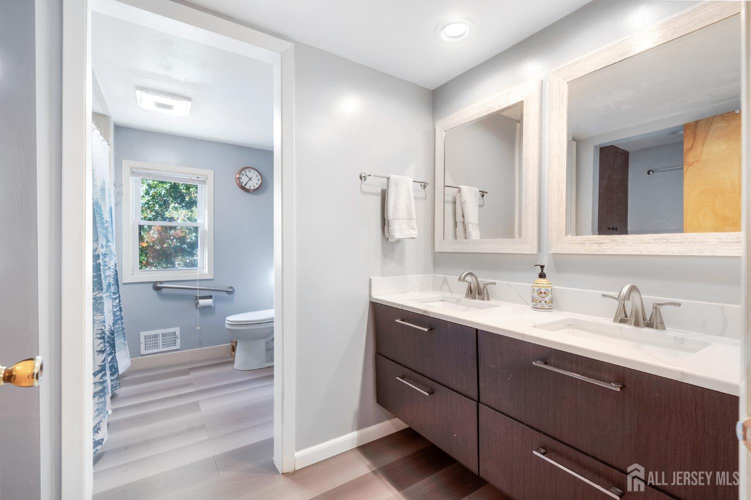 2 South Audlen Terrace Springfield, NJ 07081 - Photo 29 of 36 a bathroom with a toilet a sink a mirror and a shower