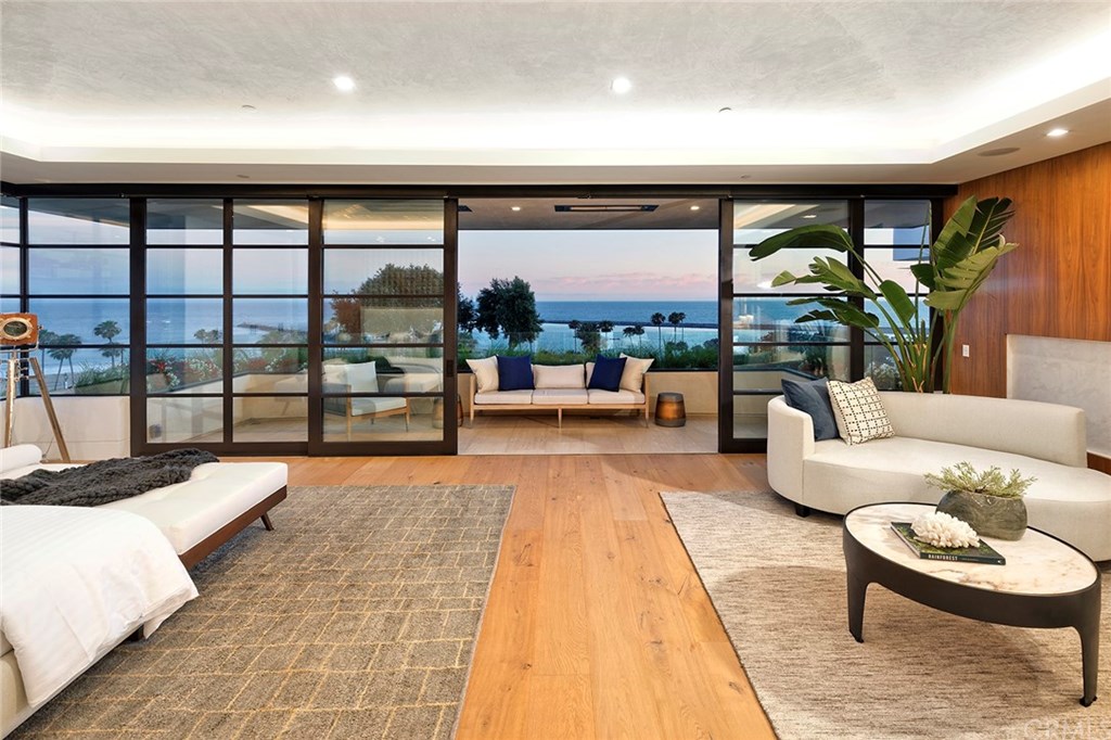 2914 Ocean Boulevard Corona del Mar, CA 92625 - Photo 29 of 60 a living room with large windows and a table