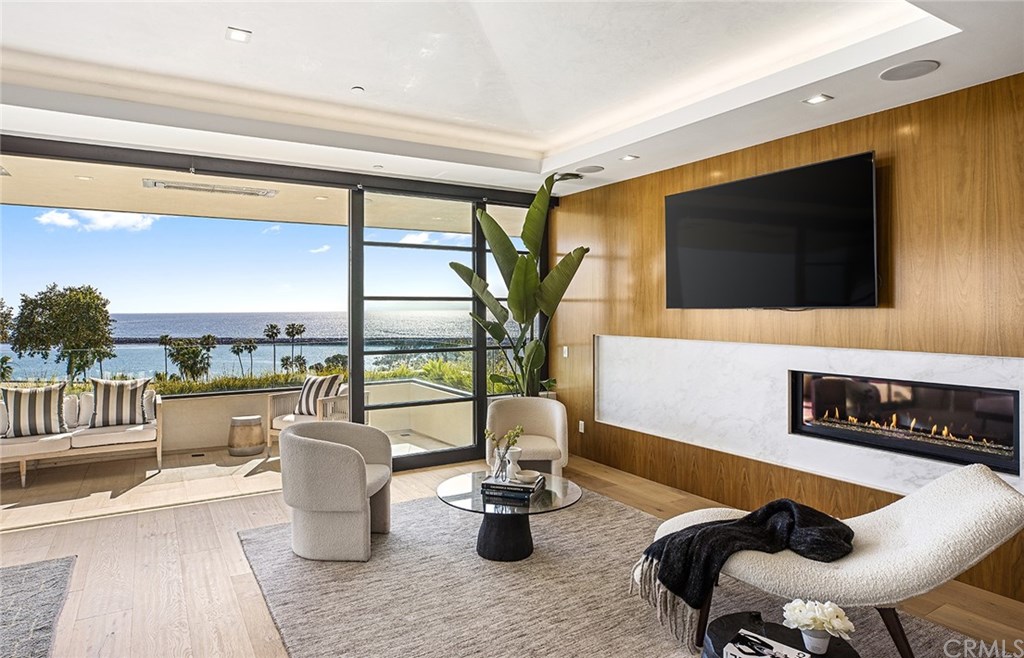 2914 Ocean Boulevard Corona del Mar, CA 92625 - Photo 33 of 60 a dining room with furniture and a floor to ceiling window