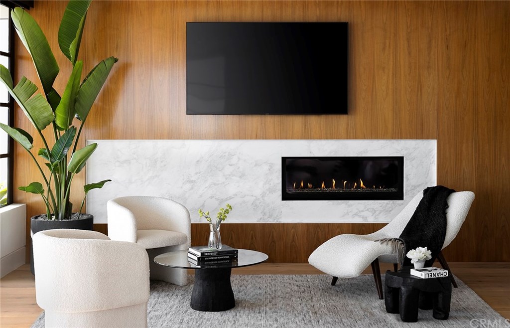 2914 Ocean Boulevard Corona del Mar, CA 92625 - Photo 35 of 60 a living room with furniture a flat screen tv and a fireplace