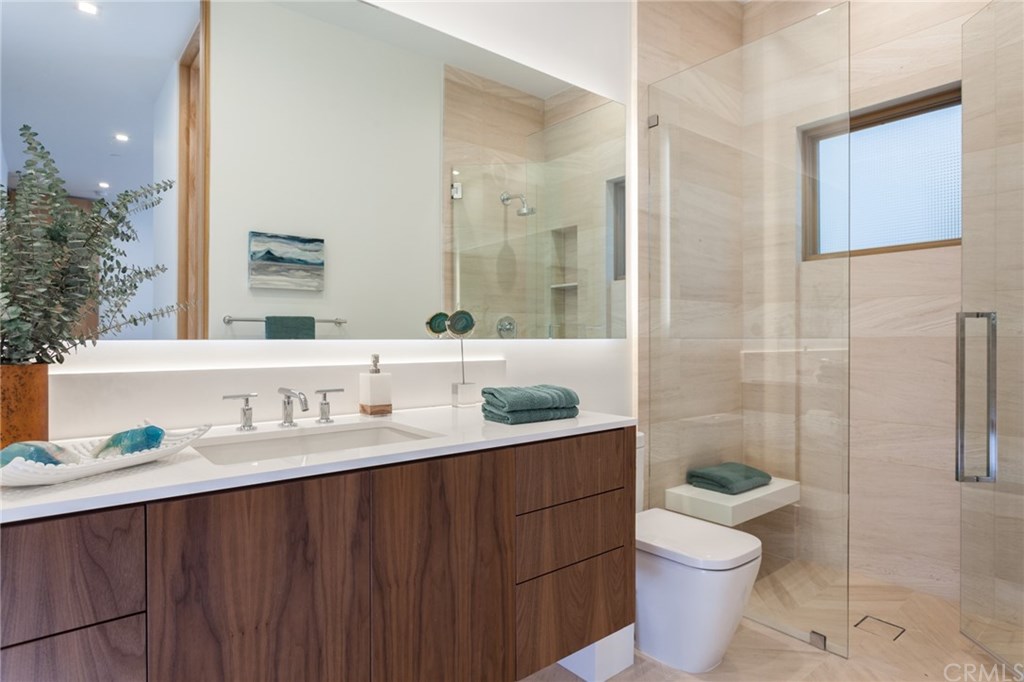 2914 Ocean Boulevard Corona del Mar, CA 92625 - Photo 51 of 60 a bathroom with a granite countertop sink toilet a mirror and shower
