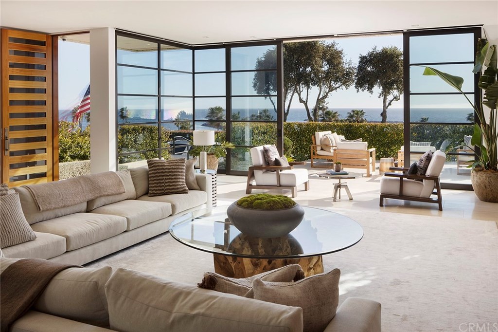 2914 Ocean Boulevard Corona del Mar, CA 92625 - Photo 10 of 60 a living room with furniture and a floor to ceiling window