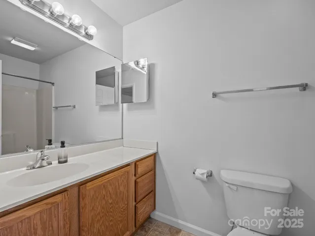 a bathroom with a sink a toilet and a mirror