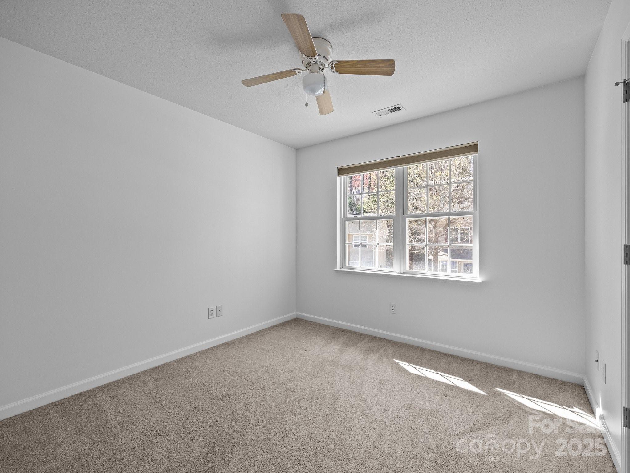 107 Alpine Ridge Drive Asheville, NC 28803 - Photo 21 of 29 an empty room with windows and ceiling fan