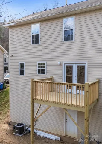 a view of a house with a small deck