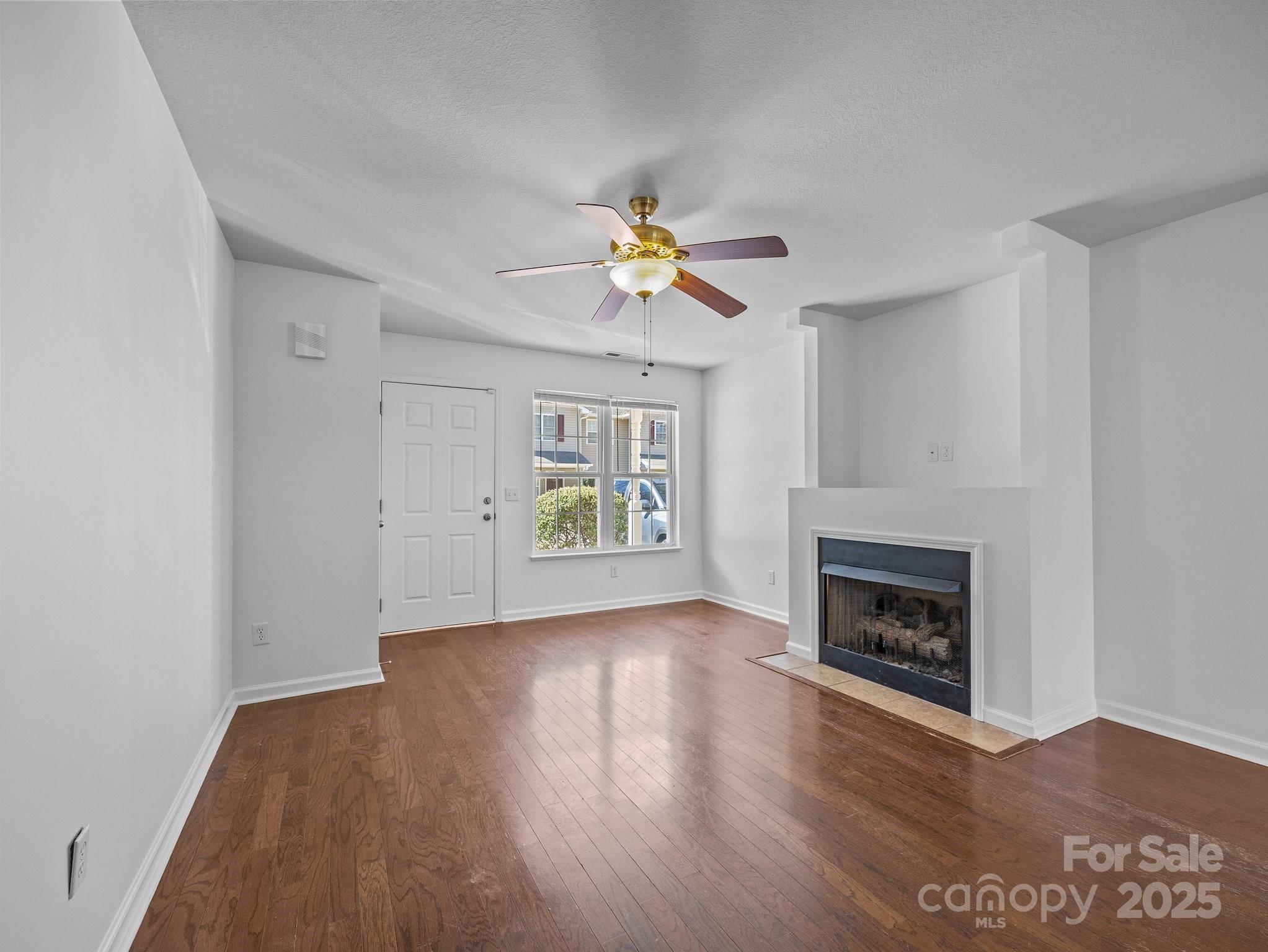 107 Alpine Ridge Drive Asheville, NC 28803 - Photo 3 of 29 a view of an empty room with window and wooden floor