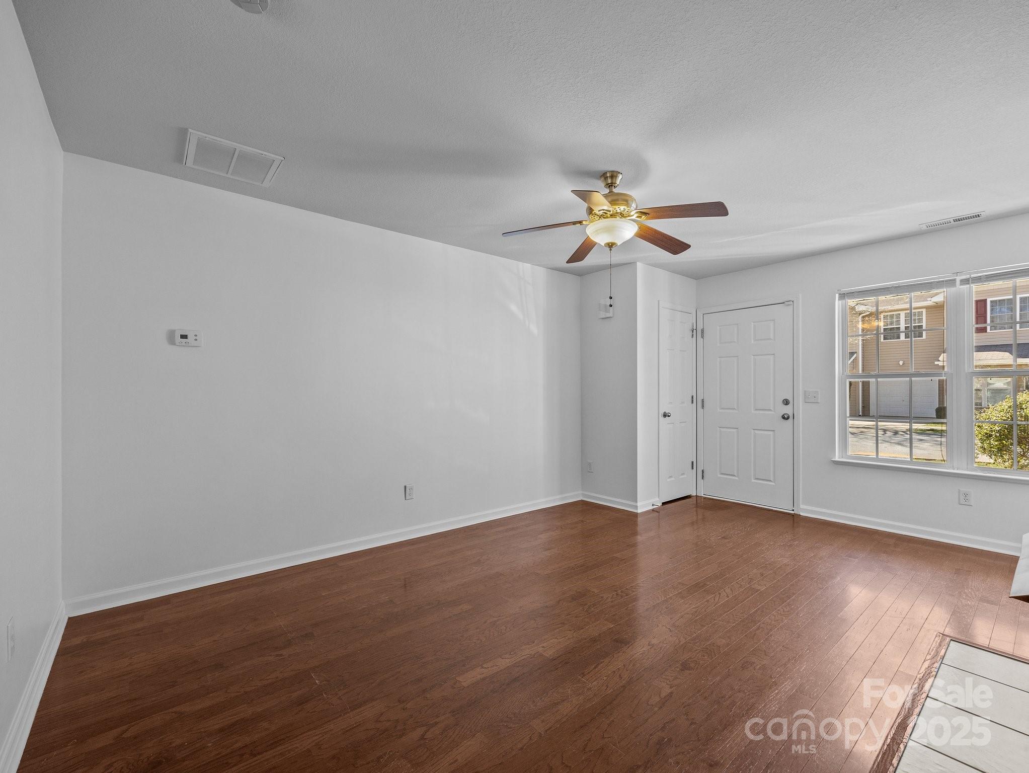 107 Alpine Ridge Drive Asheville, NC 28803 - Photo 4 of 29 an empty room with wooden floor and windows