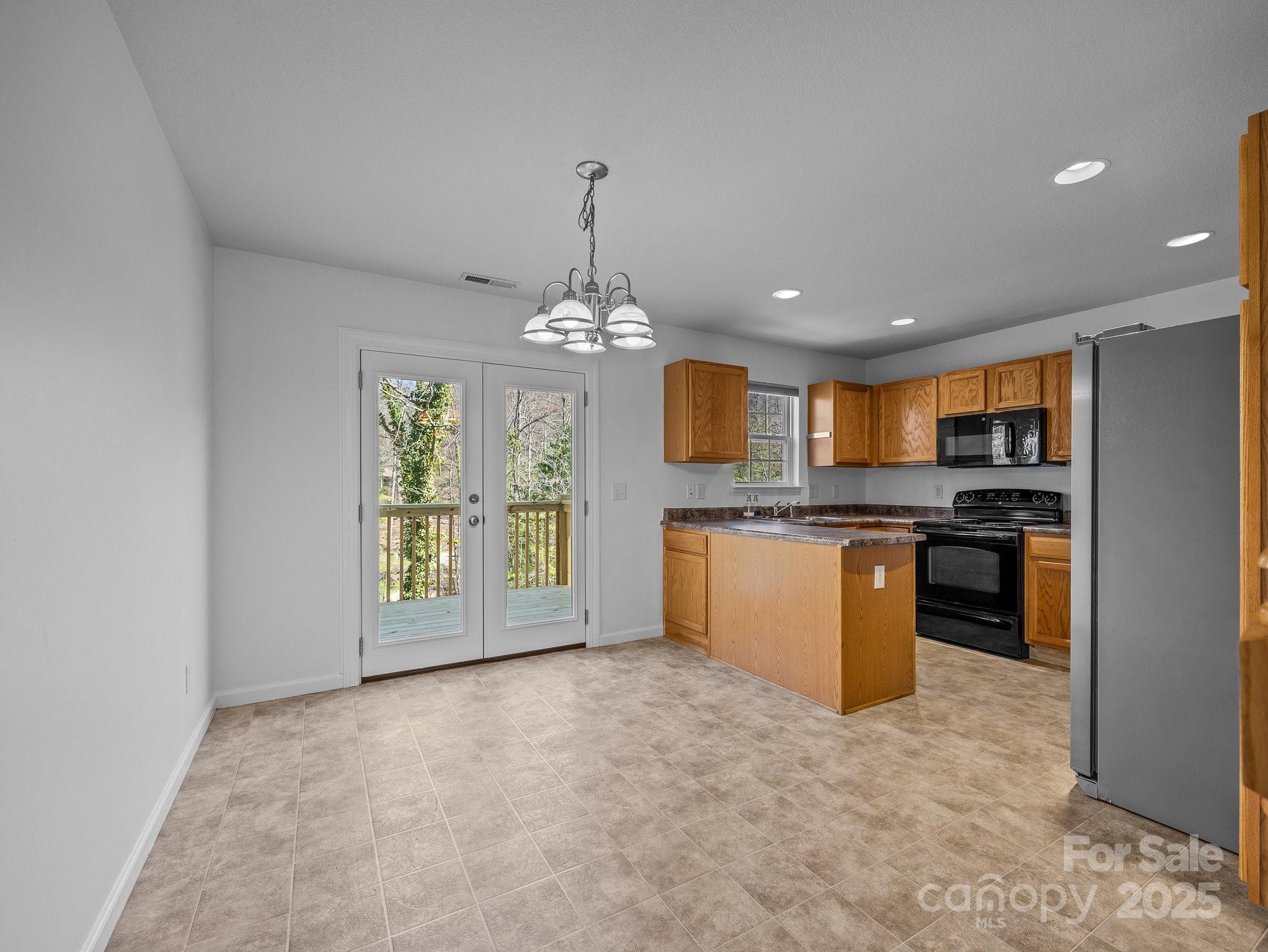 107 Alpine Ridge Drive Asheville, NC 28803 - Photo 7 of 29 a large kitchen with kitchen island granite countertop a stove top oven a sink a counter space and cabinets