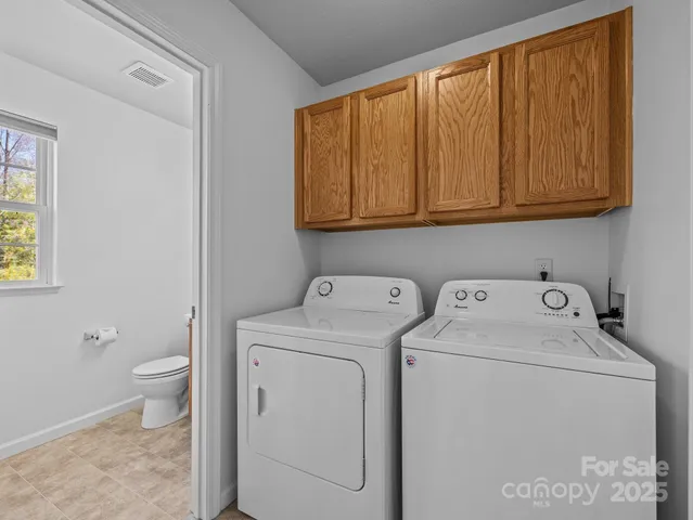 a view of bathroom with a washer and dryer